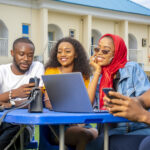 Group of young African people hanging out in an outdoor cafe